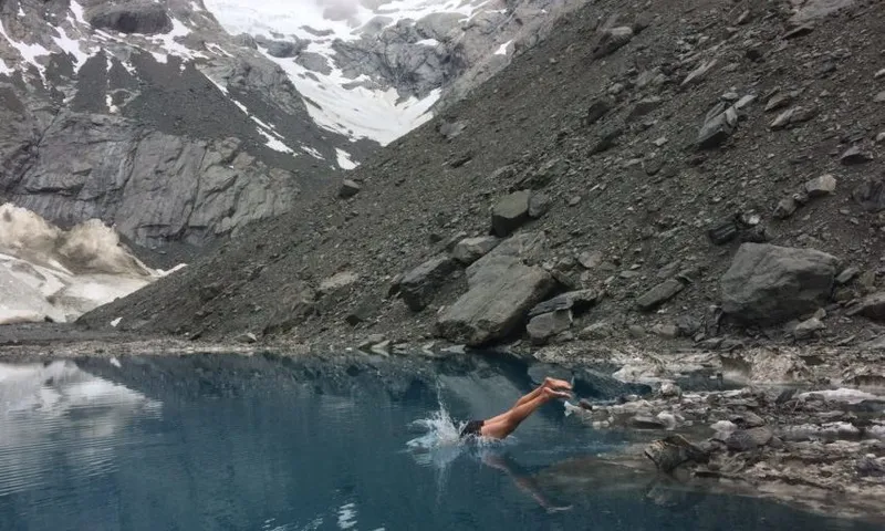 Nick Atkinson swimming in a nameless alpine lake Photo by Finn Scholes