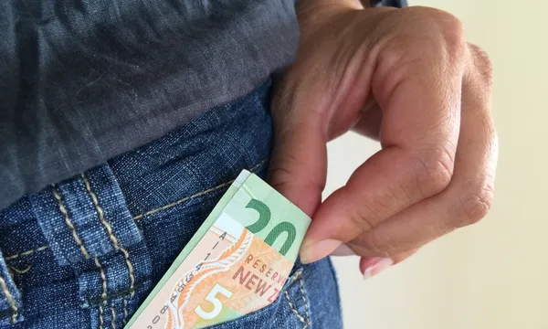 man taking money out of pocket getty