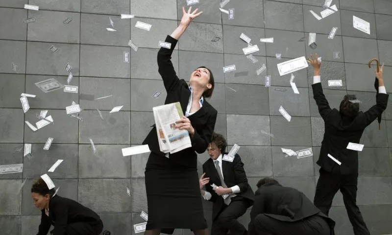 Business people on pavement catching falling money