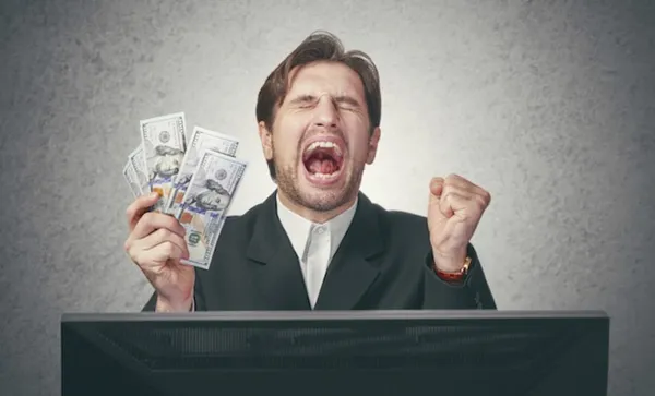 happy businessman with money in hand  and computer