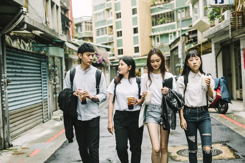 Young students talking while walking on road