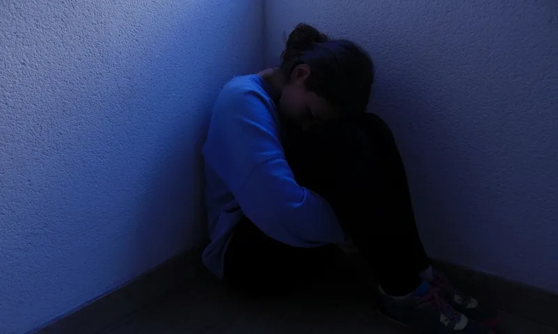 Young Woman Sitting On Floor