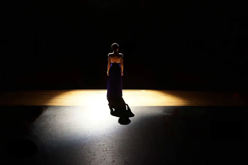 Full Length Rear View Of Woman Standing On Illuminated Stage