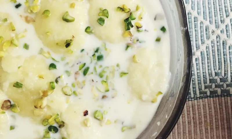 Close-up of Ras malai garnished with dried fruits