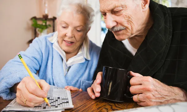 Senior couple doing crossword puzzle
