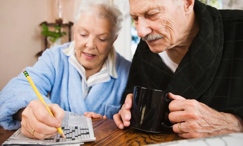 Senior couple doing crossword puzzle