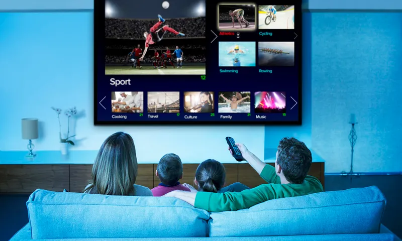Family watching television in living room