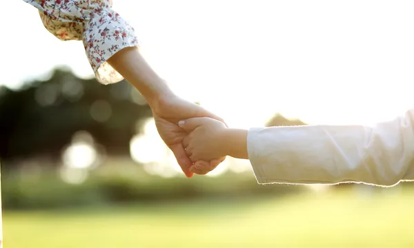 Mother walking hand in hand with daughter