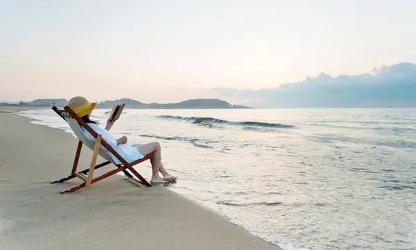 Woman reading book at the beach