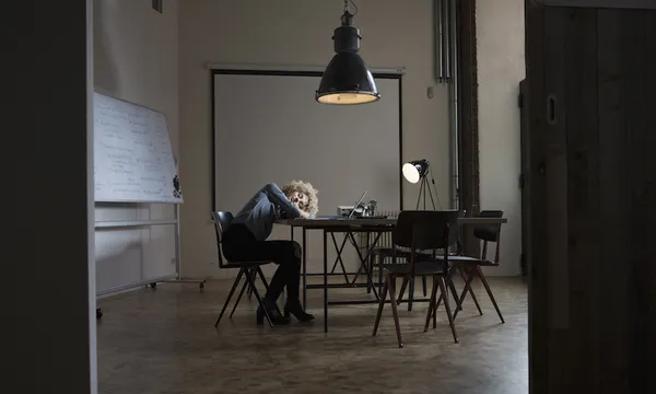 Exhausted woman in boardroom