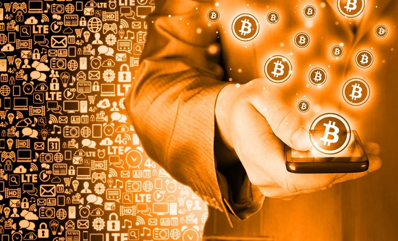 Hand with mobile smart phone and bitcoin symbol
