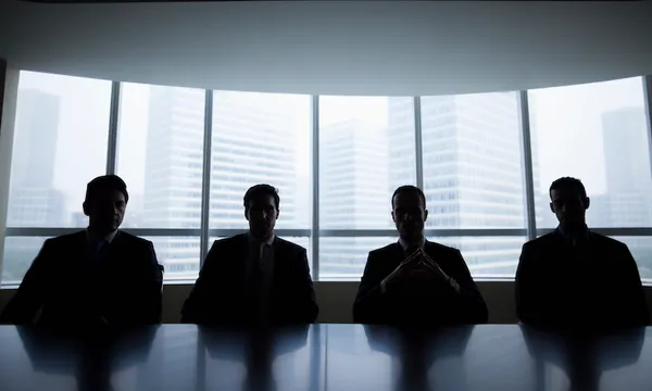 Silhouette row of businessmen sitting in meeting room
