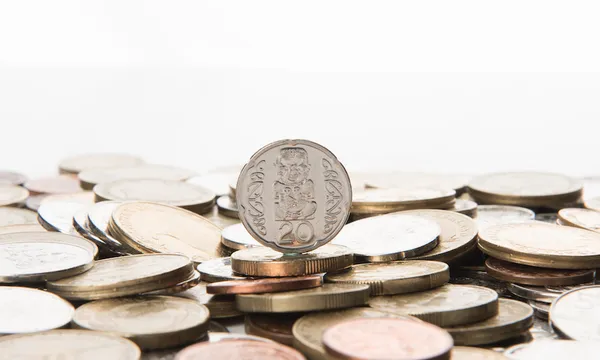 A coin stands on a pile of coins