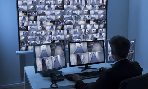 Man In Control Room Monitoring Cctv Footage