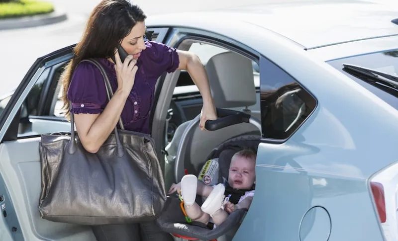 Woman traveling with baby on phone
