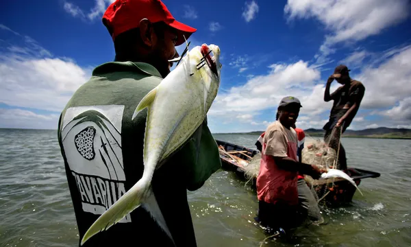 Fisherman holding his catch, Tikina Wai, Fiji