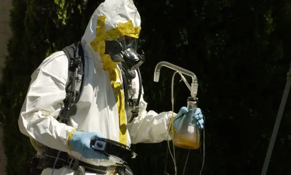(LA)DENVER, COLORADO-JULY 18, 2007-A Denver Police Department vice narcotics officer, dressed in a haz-mat suit, carries meth lab equipment from a home in the 3100 block of Umatilla Street. The Denver Fire Department discovered a meth lab in the basement