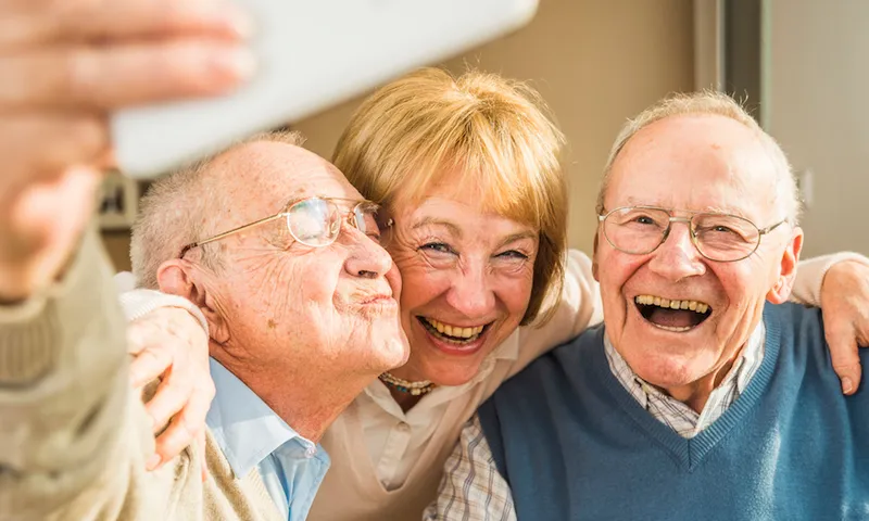 Cheerful seniors taking selfie