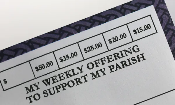 Close-up of a donation envelope for charitable support at a religious organization