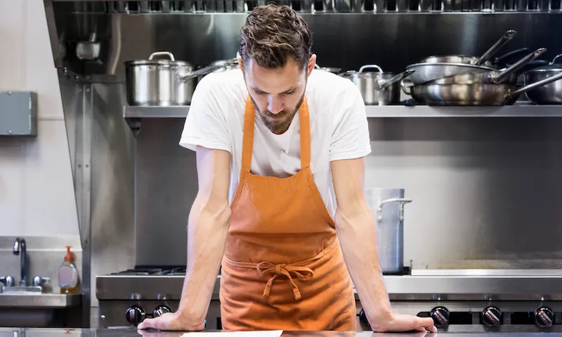 Chef reading menu in commercial kitchen