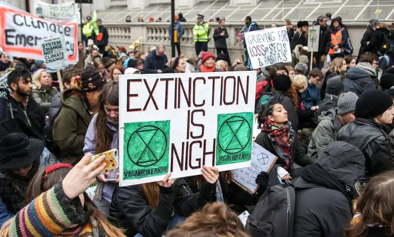 A climate change activist seen holding a placard during the