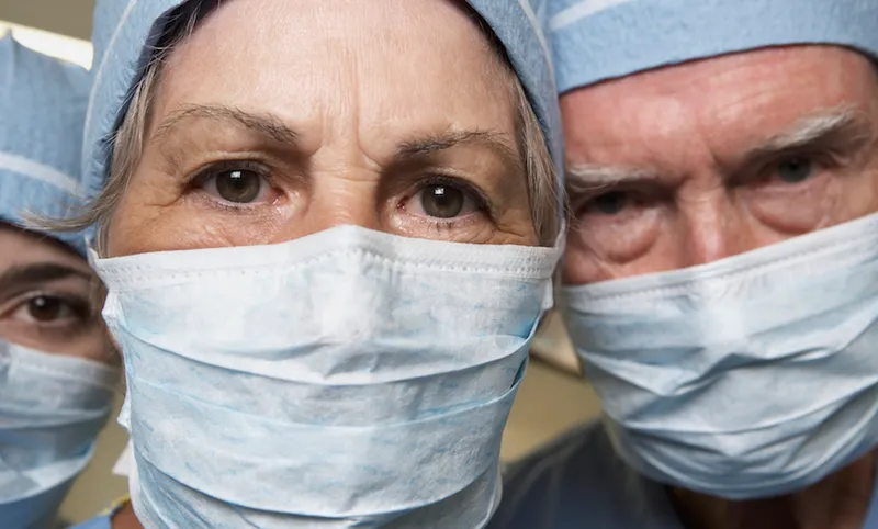 Close up of senior male and female doctors in surgical masks