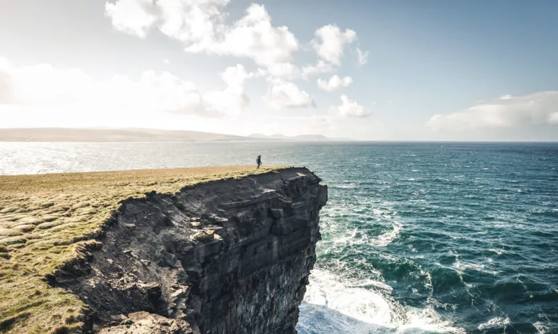 Silhouette Of Man On Rock By Sea Against Sky