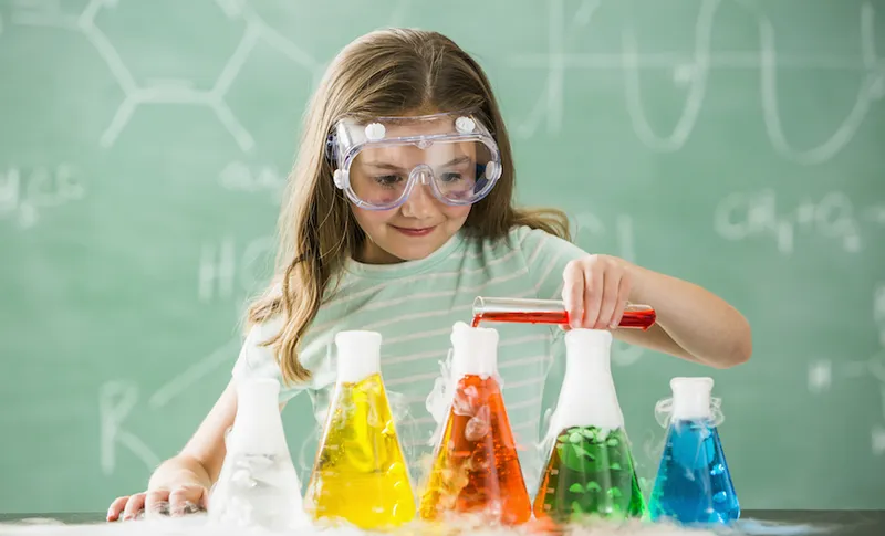 Caucasian girl doing science experiment in classroom