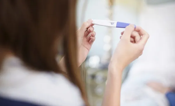 Girl holding a pregnancy test