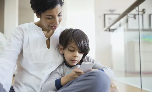 Mother and son using cell phone