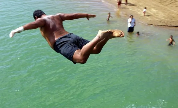 Locals take some time out of diving and swimming.