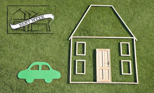 Outline of house and car in grass