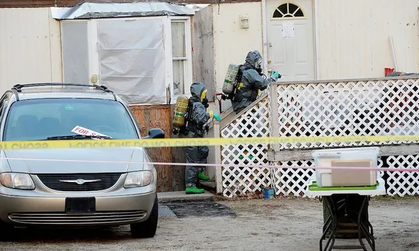 Members of the Maine Drug Enforcement Agency investigate a possible methamphetamine lab in Buxton