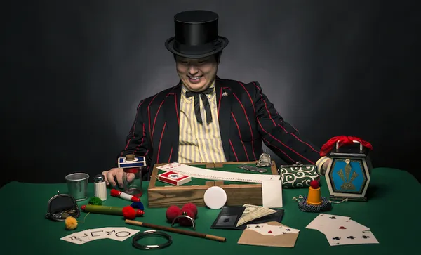 A magician sitting with his tricks