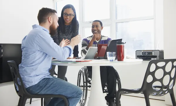 Business people using laptops at table