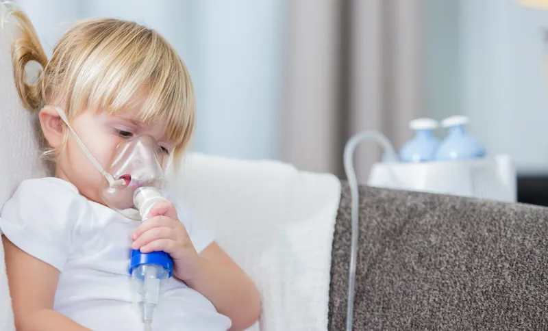 Adorable little girl receives breathing treatment