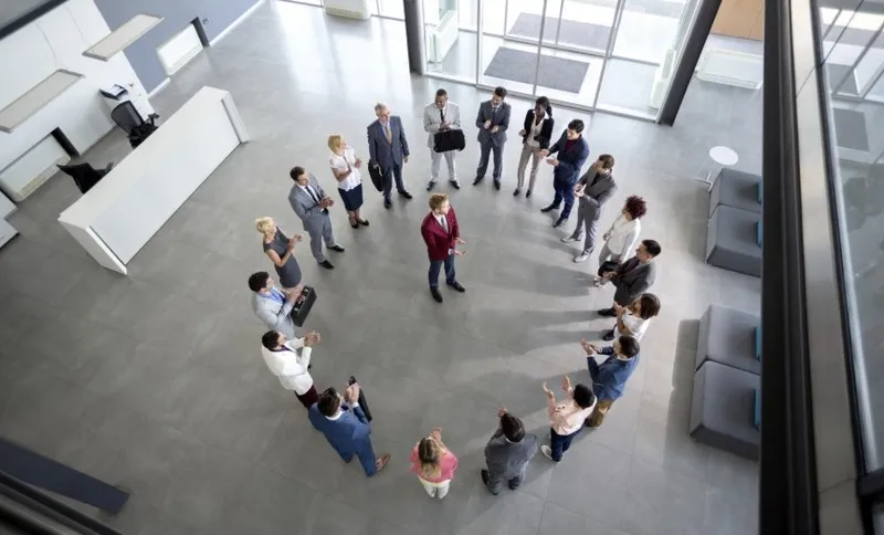 Working team with manager in centre of circle