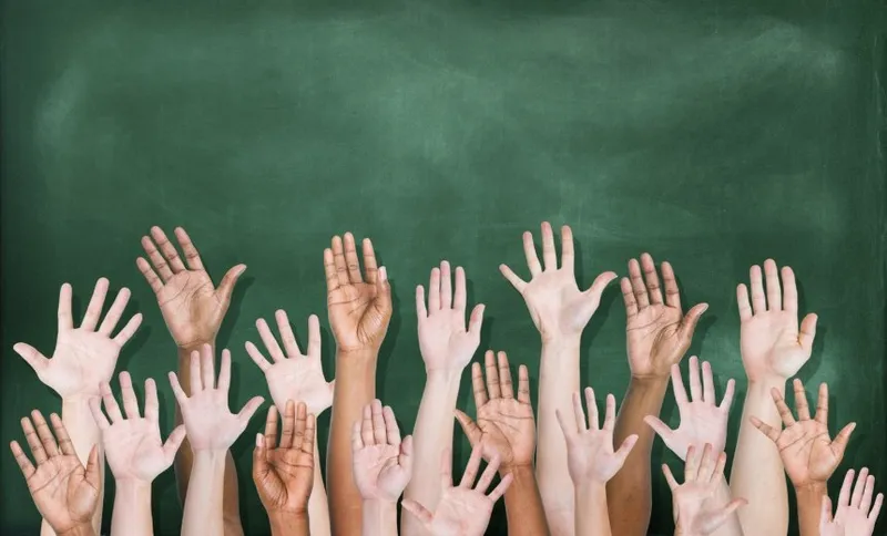 Multiethnic Group of Hands Raised with Blackboard