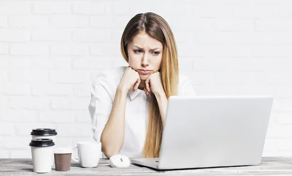 Stressed business woman working on a laptop