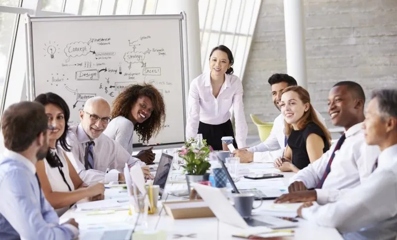 Asian Businesswoman Leading Meeting At Boardroom Table