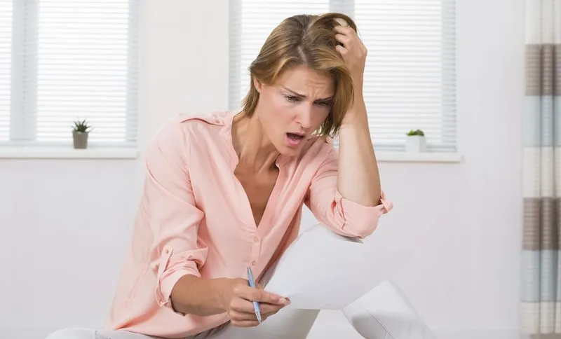 Shocked Woman Looking At Paper