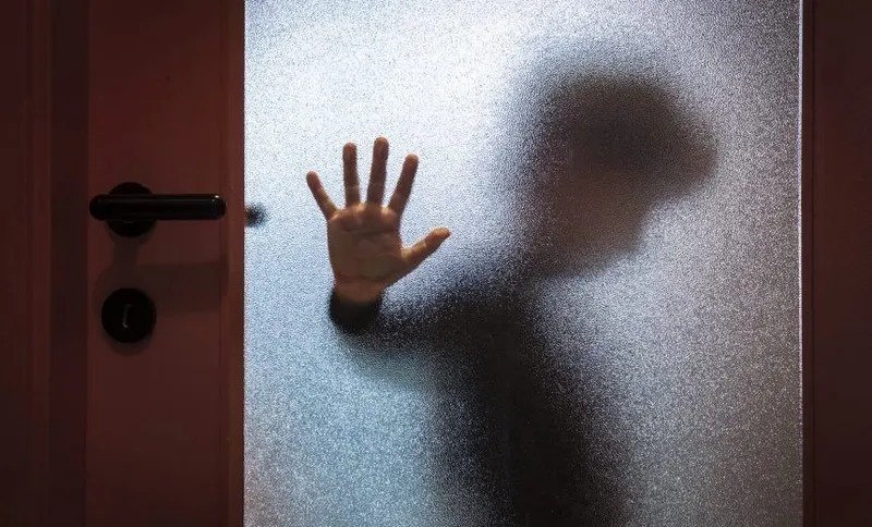 Boy Behind Glass Door
