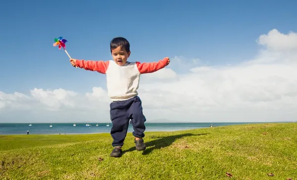 Kid playing with paper Pinwheel.