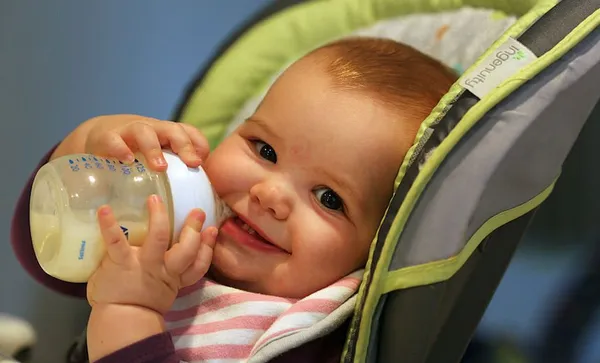 A nine month old baby girl at meal time.