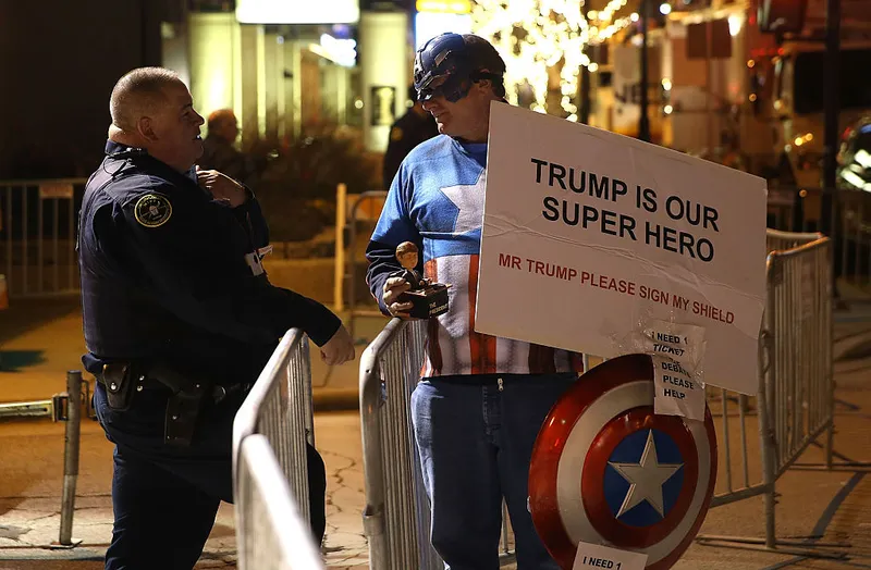 MILWAUKEE, WI - NOVEMBER 10:  A supporter of republican presidential candidate Donald Trump wears a Captain America outfit outside of the Republican Presidential Debate sponsored by Fox Business and the Wall Street Journal at the Milwaukee Theatre on November 10, 2015 in Milwaukee, Wisconsin. The fourth Republican debate is held in two parts, one main debate for the top eight candidates, and another for four other candidates lower in the current polls.  (Photo by Justin Sullivan/Getty Images)