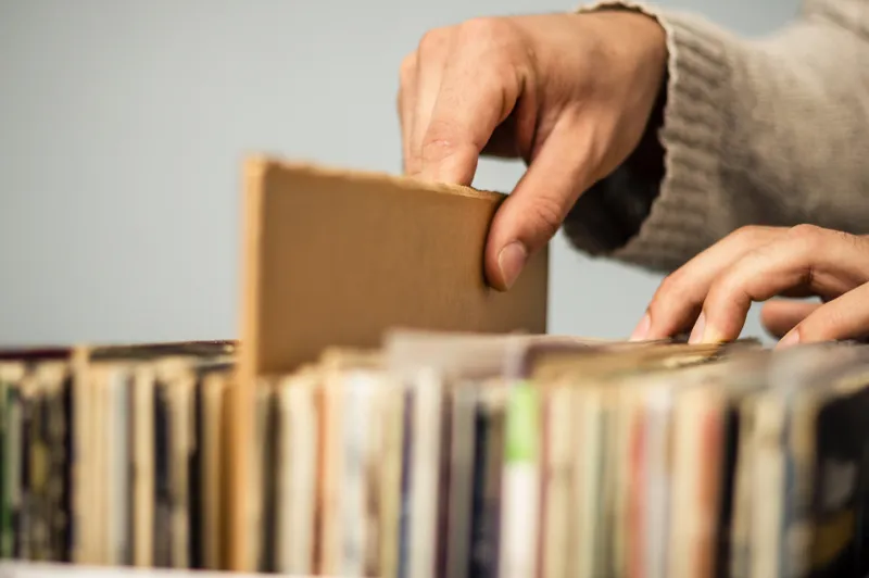 Close up on hands browsing record store