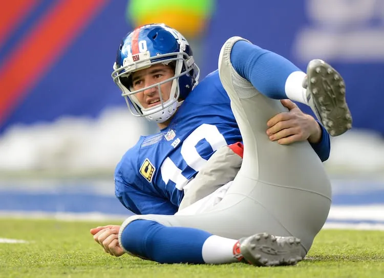 EAST RUTHERFORD, NJ - DECEMBER 15: Quarterback Eli Manning #10 lays on the ground in the 1st half  against the Seattle Seahawks at MetLife Stadium on December 15, 2013 in East Rutherford, New Jersey. (Photo by Ron Antonelli/Getty Images)