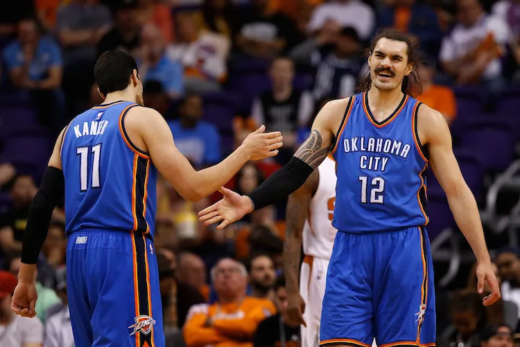 PHOENIX, AZ - FEBRUARY 08:  Steven Adams #12 of the Oklahoma City Thunder high-fives Enes Kanter #11 after scoring against the Phoenix Suns during the second half of the NBA game at Talking Stick Resort Arena on February 8, 2016 in Phoenix, Arizona.  The Thunder defeated the Suns 122-106. NOTE TO USER: User expressly acknowledges and agrees that, by downloading and or using this photograph, User is consenting to the terms and conditions of the Getty Images License Agreement.  (Photo by Christian Petersen/Getty Images)
