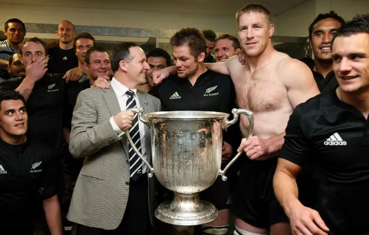 SYDNEY, AUSTRALIA - AUGUST 22:  (L-R) New Zealand Prime Minister John Key, All Blacks captain Richie McCaw and Brad Thorn of the All Black celebrate after the 2009 Tri Nations series Bledisloe Cup match between the Australian Wallabies and the New Zealand All Blacks at ANZ Stadium on August 22, 2009 in Sydney, Australia.  (Photo by Mark Nolan/Getty Images)