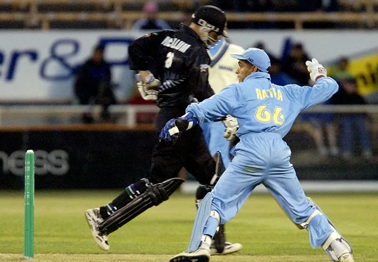 India's wicketkeeper Ratra throws the ball to the other end as Black Max batsman Brendon McCallum runs past during the Super Max cricket international at Jade Stadium,Wednesday. (Photo by Simon Baker/Getty Images)